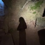 Ombre de Christel Dijoux dans une crypte souterraine, évoquant l'exploration de soi et son développement personnel.
