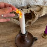 Christel Dijoux, allumant une bougie pour préparer une séance de magnétisme et d'hypnose dans son cabinet de Rimont.